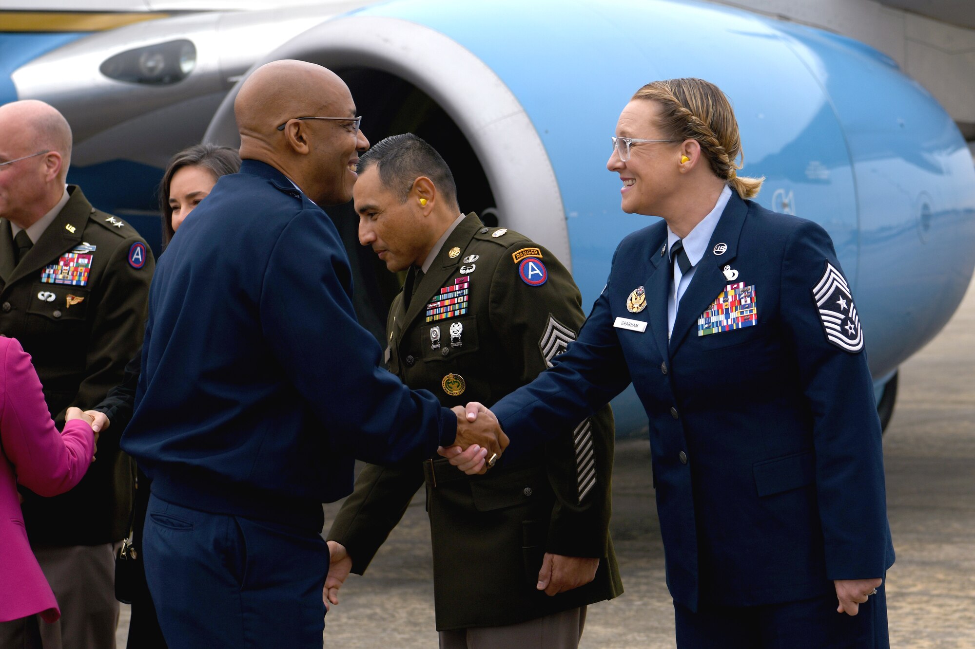 Men and women shake hands.