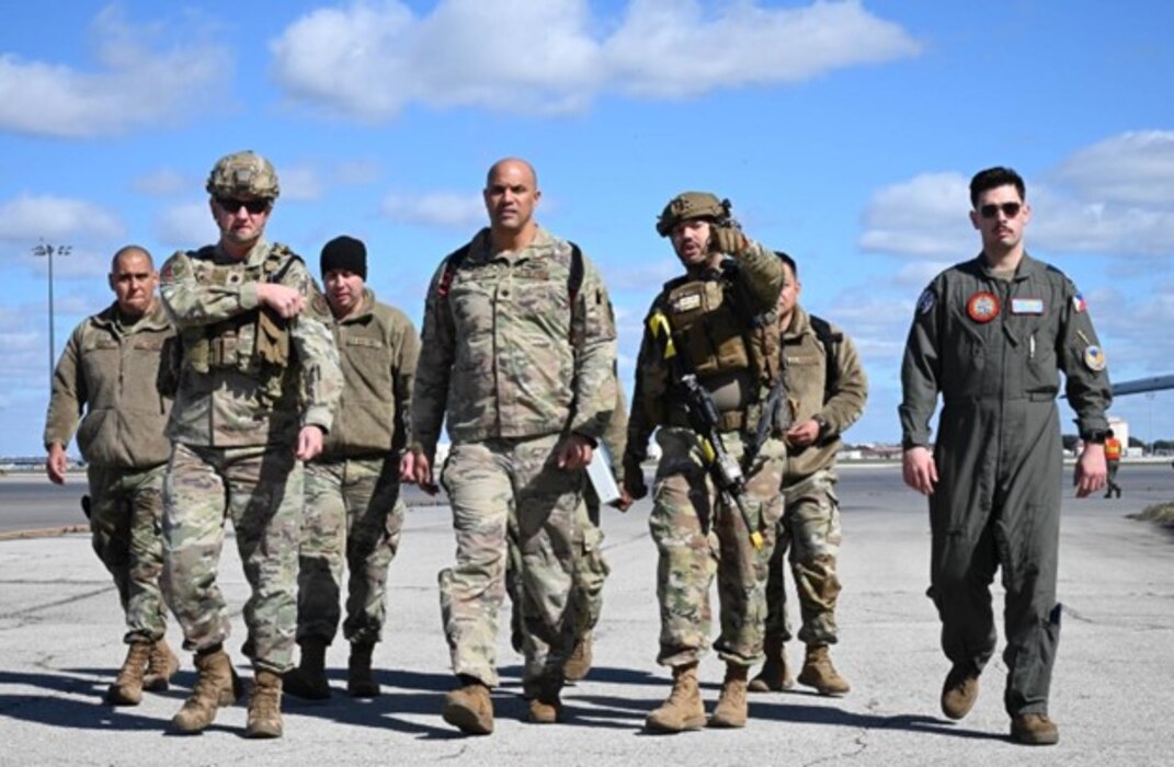 Lt. Col. Christopher Jones (center), Exercise Dragon’s Den deployed combatant commander, is accompanied by fellow exercise players, and Senior Airman Gundogdu (far right), acting as a host-nation commander, arriving at a deployed exercise location at Joint Base San Antonio-Lackland, Texas Feb. 6, 2024.