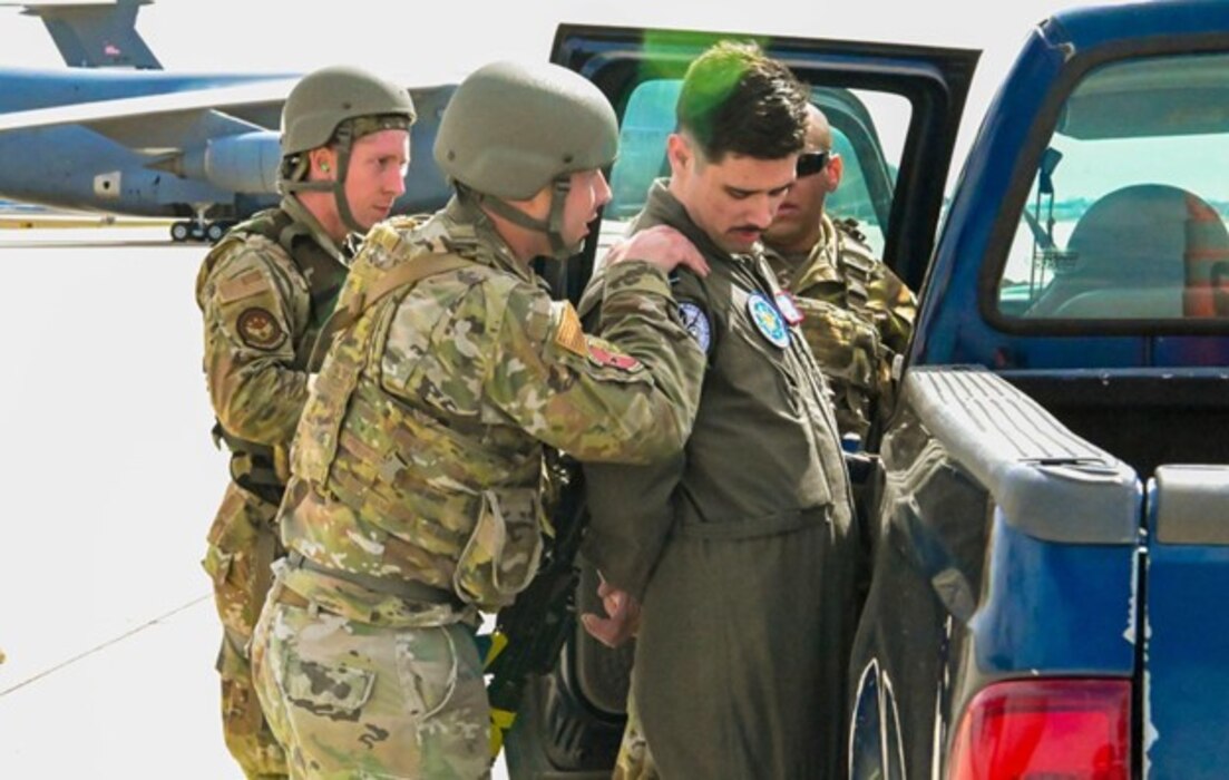 433rd Security Forces Squadron Defenders search and question Senior Airman Ali Gundogdu, a 68th Airlift Squadron loadmaster, after he played the part of a hijacker during Exercise Dragon’s Den at Joint Base San Antonio-Lackland, Texas on Feb. 7, 2024.