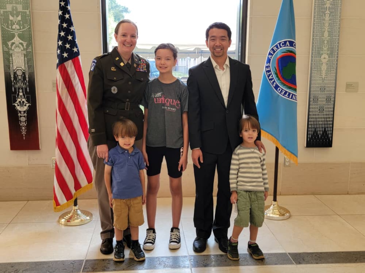Nebraska Army National Guard Maj. Jessica Pan poses with her husband and three children after her promotion ceremony to the rank of major, Feb. 22, 2023, at the U.S. Embassy in Kigali, Rwanda.