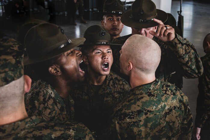 U.S. Marine Corps drill instructors with Mike Company, 3rd Recruit Training Battalion, inspect a recruit during a senior drill instructor inspection at Marine Corps Recruit Depot San Diego, Feb. 8, 2024. The SDI Inspection is the first of several inspections recruits will undergo throughout the duration of their training at MCRD San Diego and aims to ensure the recruits are upholding the uniform orders given to them. (U.S. Marine Corps photo by Sgt. Yvonna Guyette)