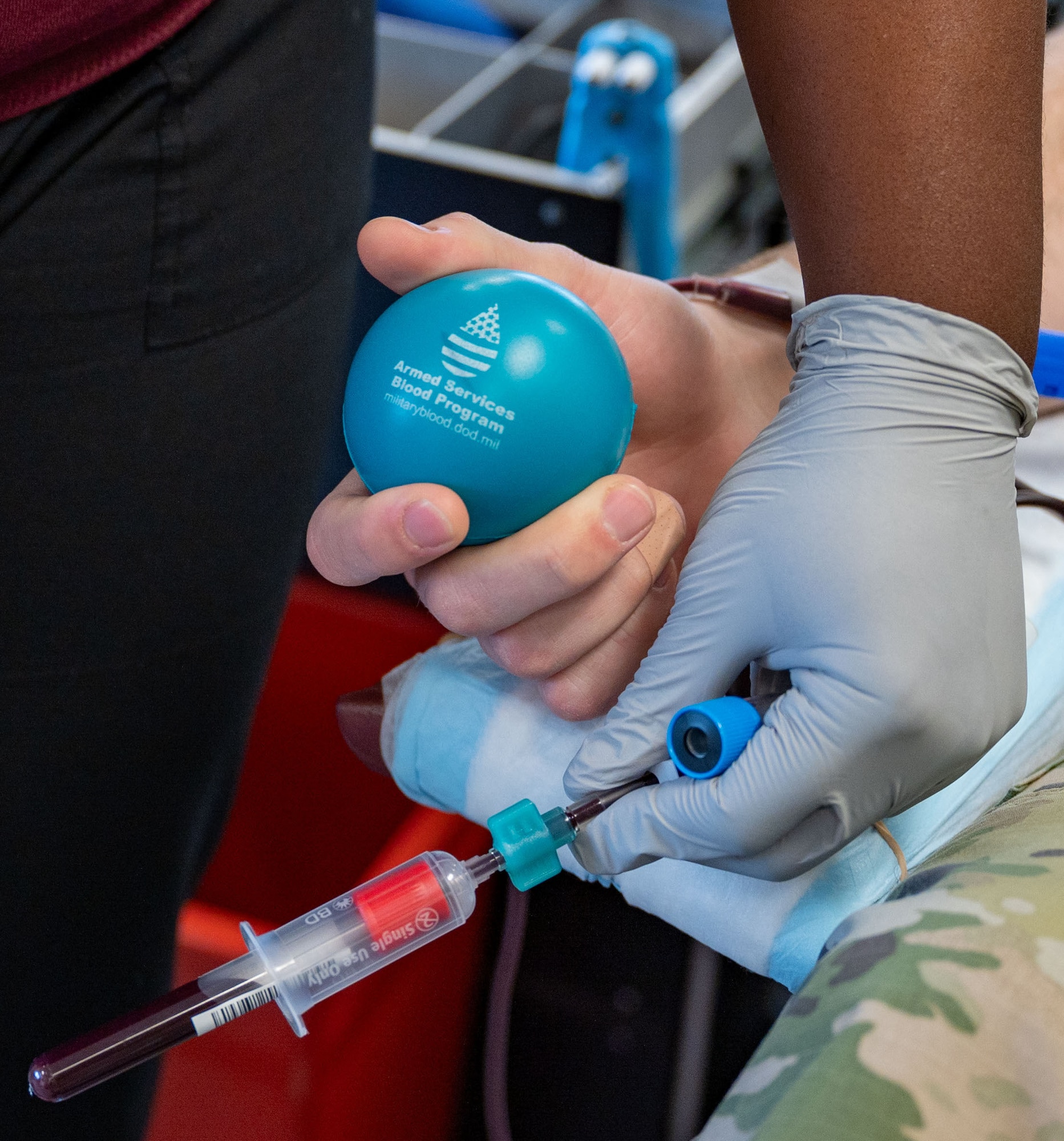 A Team Dover Airman holds on to a stress ball during the Armed Services Blood Program blood drive at Dover Air Force Base, Delaware, Feb. 12, 2024. Team Dover collectively donated 31 units of blood during the drive which has the potential to save 63 lives. (U.S. Air Force photo by Airman 1st Class Amanda Jett)