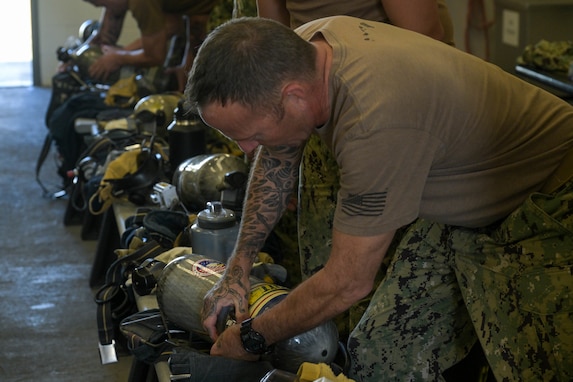 Sailors put on self-contained breathing apparatuses during training to manage access control points at the Red Hill Bulk Fuel Storage Facility (RHBFSF), in preparation to transition responsibility for the facility from Joint Task Force-Red Hill (JTF-RH) to Navy Closure Task Force - Red Hill (NCTF-RH) at Joint Base Pearl Harbor-Hickam, Hawaii on Feb. 7, 2024.