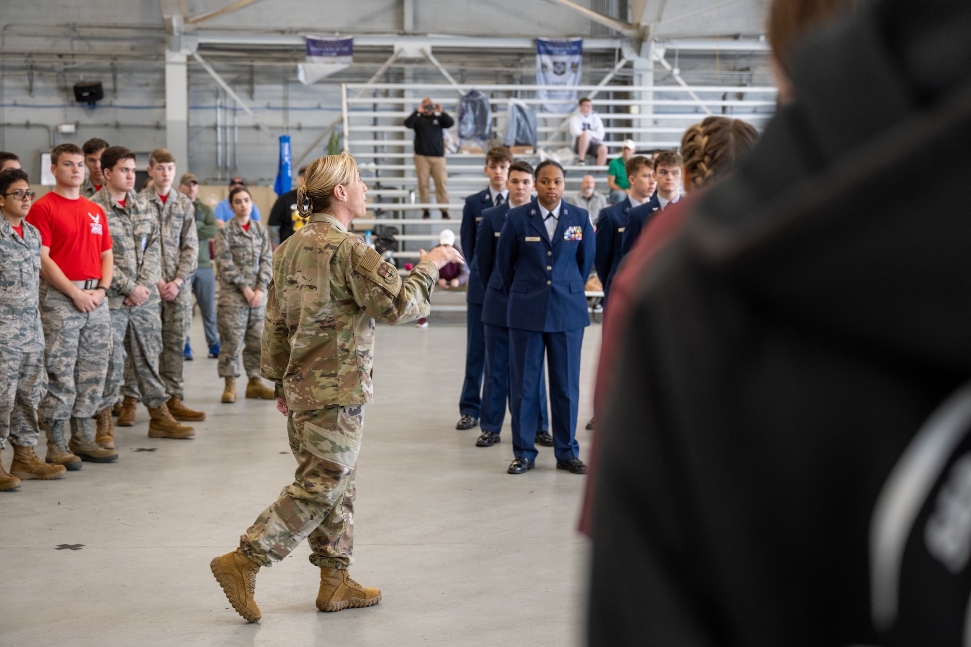 U.S. Air Force Col. Allison Black, 1st Special Operations Wing Commander, gives opening remarks during the Air Force Junior ROTC drill competition at the Commando Hanger at Hurlburt Field, Florida, Feb. 10, 2024. Team Hurlburt is committed to fostering key relationships in order to bolster community bonds by organizing events such as the drill competition. (U.S. Air Force photo by Senior Airman Alysa Calvarese)