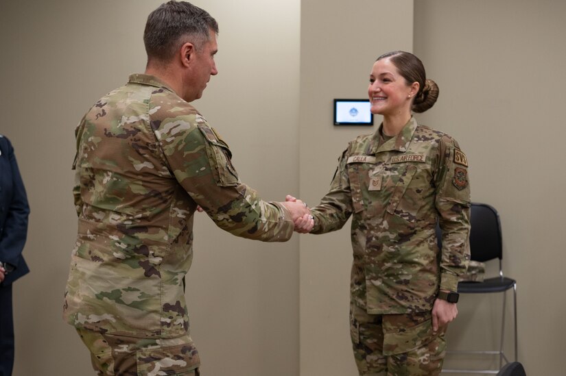 U.S. Air Force Maj. Gen. John Klein, U.S. Air Force Expeditionary Center commander, shakes hands Tech. Sgt. Kristina Calla, Military Family Readiness Center readiness noncommissioned officer in charge, during a tour of Joint Base McGuire-Dix-Lakehurst, N.J., Feb. 8, 2024. The tour included stops at unaccompanied housing dorms, the Oasis Lounge and the Airman Leadership School. (U.S. Air Force photo by Staff Sgt. Monica Roybal)