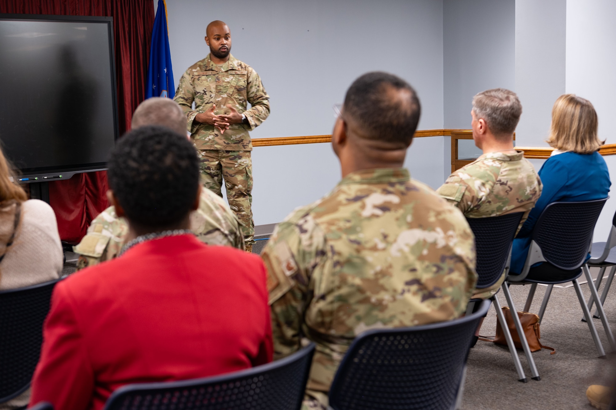 U.S. Air Force Staff Sgt. Daniel Dennis, Airman Leadership School instructor, briefs Maj. Gen. John Klein, U.S. Air Force Expeditionary Center commander, and Chief Master Sgt. Courtney Freeman, USAFEC command chief, during a tour of Joint Base McGuire-Dix-Lakehurst, N.J., Feb. 8, 2024. The tour included stops at unaccompanied housing dorms, the First Term Enlisted Center and the Airman Leadership School. (U.S. Air Force photo by Staff Sgt. Monica Roybal)