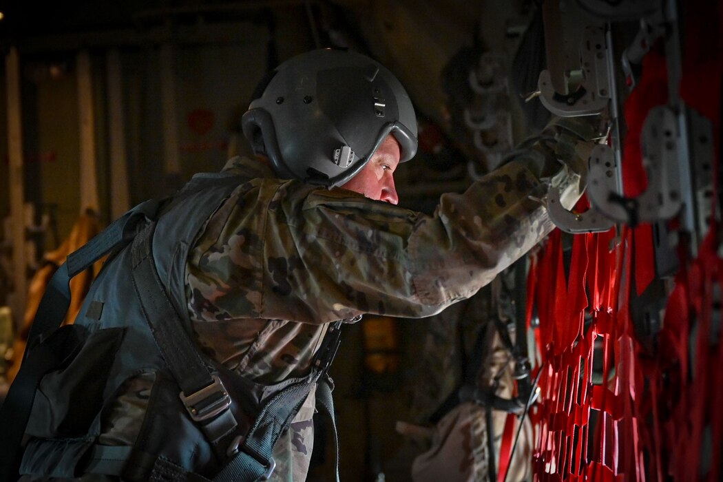 An Airman looks out a C-130J Super Hercules aircraft window