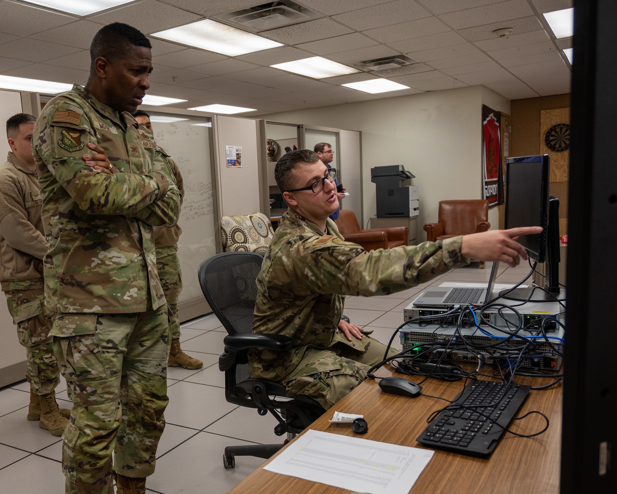 U.S. Air Force Senior Airmen Jerremy Huck, 47th Communications Squadron (CS) technician, shows Col. Robert Moore, 47th Mission Support Group commander, how to set up a new switch on a monitor at Laughlin Air Force Base, Texas, Feb. 6, 2024. The installation of new switches by the 47th CS improves digital security and data transfer speeds throughout the base. (U.S. Air Force photo by Staff Sgt. Nicholas Larsen)