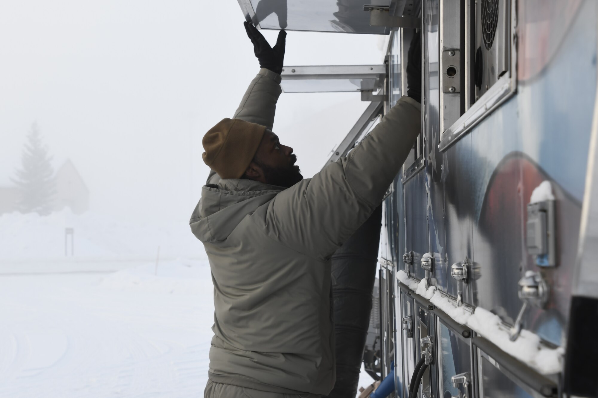 168th Services Airman, Tech Sgt. JeanPaul Williams, prepares and tests the Disaster Relief Mobile Kitchen trailer in -40 degree temperatures.