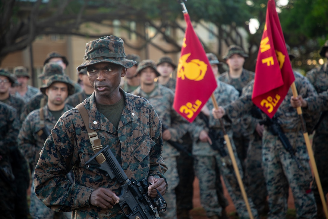 U.S. Marine Corps Lt. Col. Osman Sesay gives his remarks after a six-mile conditioning hike on Marine Corps Base Hawaii, Jan. 26, 2024. Conditioning hikes consist of carrying heavy loads for long distances to test and improve physical fitness, mental fortitude, and unit comradery. Sesay, a native of Sierra Leone, West Africa, is the commanding officer of 3d Littoral Logistics Battalion, 3d Marine Littoral Regiment, 3d Marine Division. (U.S. Marine Corps photo by Sgt. Jacqueline C. Parsons)