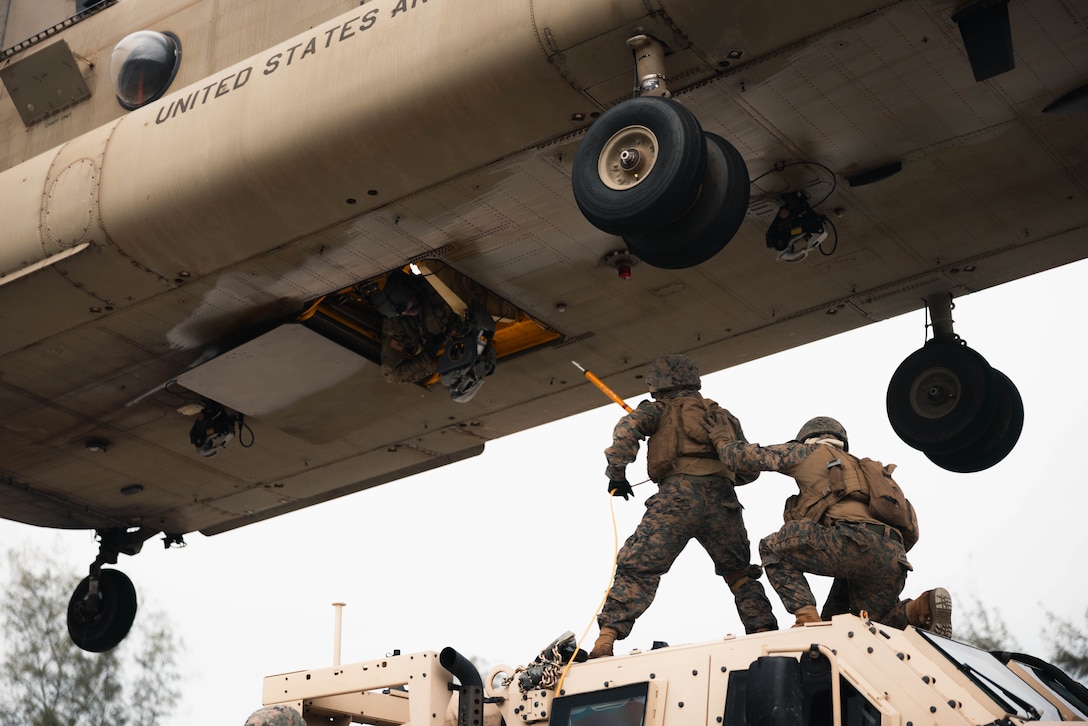 U.S. Marines with 3d Littoral Logistics Battalion, 3d Marine Littoral Regiment, 3d Marine Division, prepare to hook a Joint Light Tactical Vehicle onto a Army CH-47 Chinook during the 3d Littoral Logistics Battalion’s Helicopter Support Team training at Marine Corps Training Area Bellows, Hawaii, Feb. 2, 2024. The 3d LLB undergoes transportation training under the pressure of a tactical scenario in order to prepare realistically for future operations. (U.S. Marine Corps photo by Cpl. Eric Huynh)