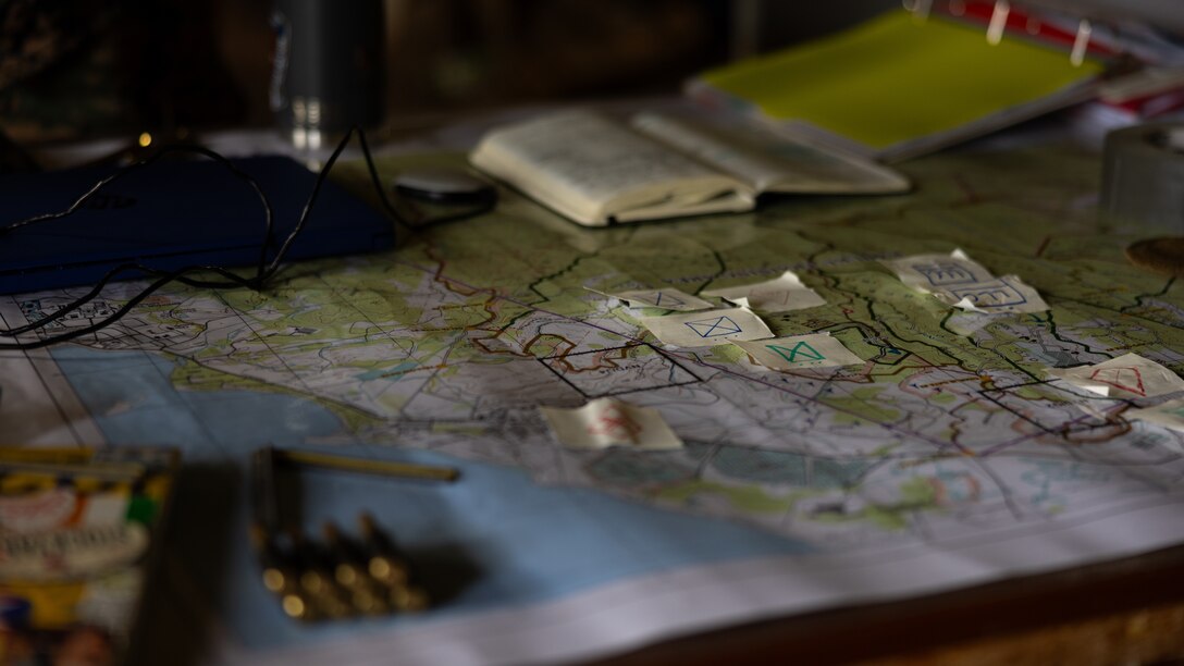 A map is marked with objective points and other key features during a field exercise at Kahuku Training Area, Hawaii, Feb. 7, 2024. During the training, U.S. Marines with 3d Littoral Logistics Battalion, 3d Marine Littoral Regiment, 3d Marine Division conducted tactical logistic operations, supporting 3d MLR units while confronted with notional enemy interference. (U.S. Marine Corps photo by Sgt. Jacqueline C. Parsons)