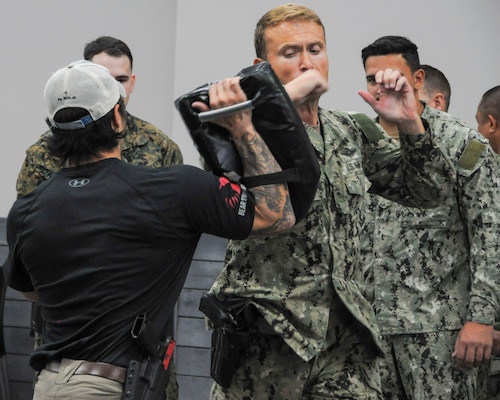 Lt. Cmdr. Michael Austin, a preventative medicine technician with Forward Deployable Preventative Medical Unit Six (FDPMU-6) performs a horizontal elbow strike during unique Weapons and Threat Recognition Training Course, Feb. 5, 2024, in Suffolk, Virginia. The training was specifically designed and tailored for FDPMU’s, to ensure service members are prepared for upcoming deployments. The course prepares members to efficiently operate weapon systems, while performing required duties, and enables them to execute close quarter combatives if necessary while out in a deployed environment. (U.S. Navy photo by Desmond Martin)