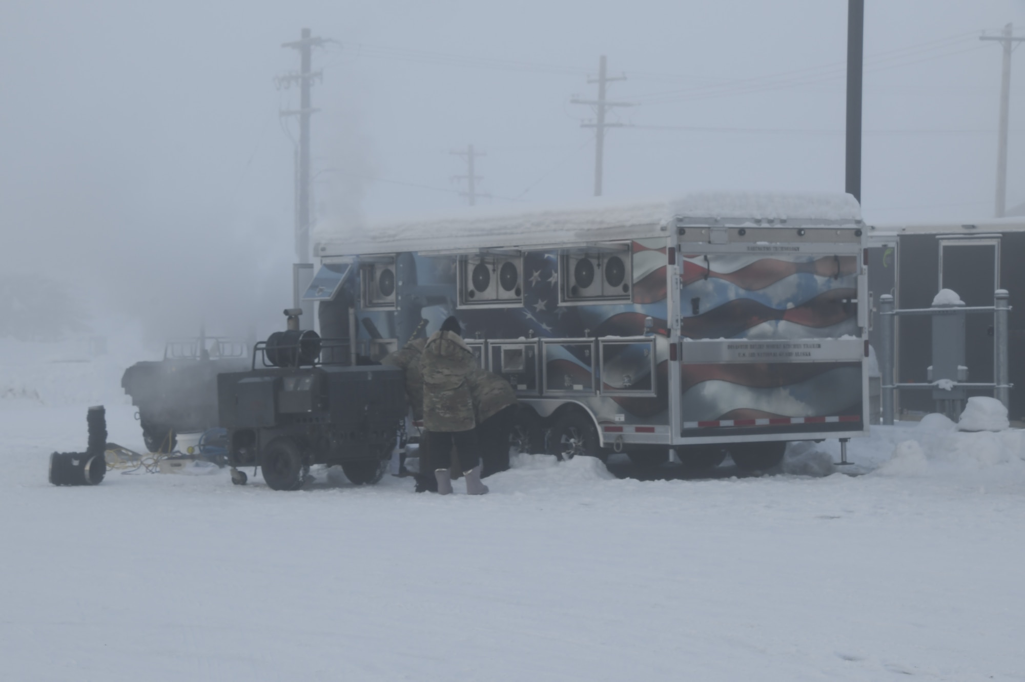 168th Services Airmen prepare and test the Disaster Relief Mobile Kitchen trailer in -40 degree temperatures.