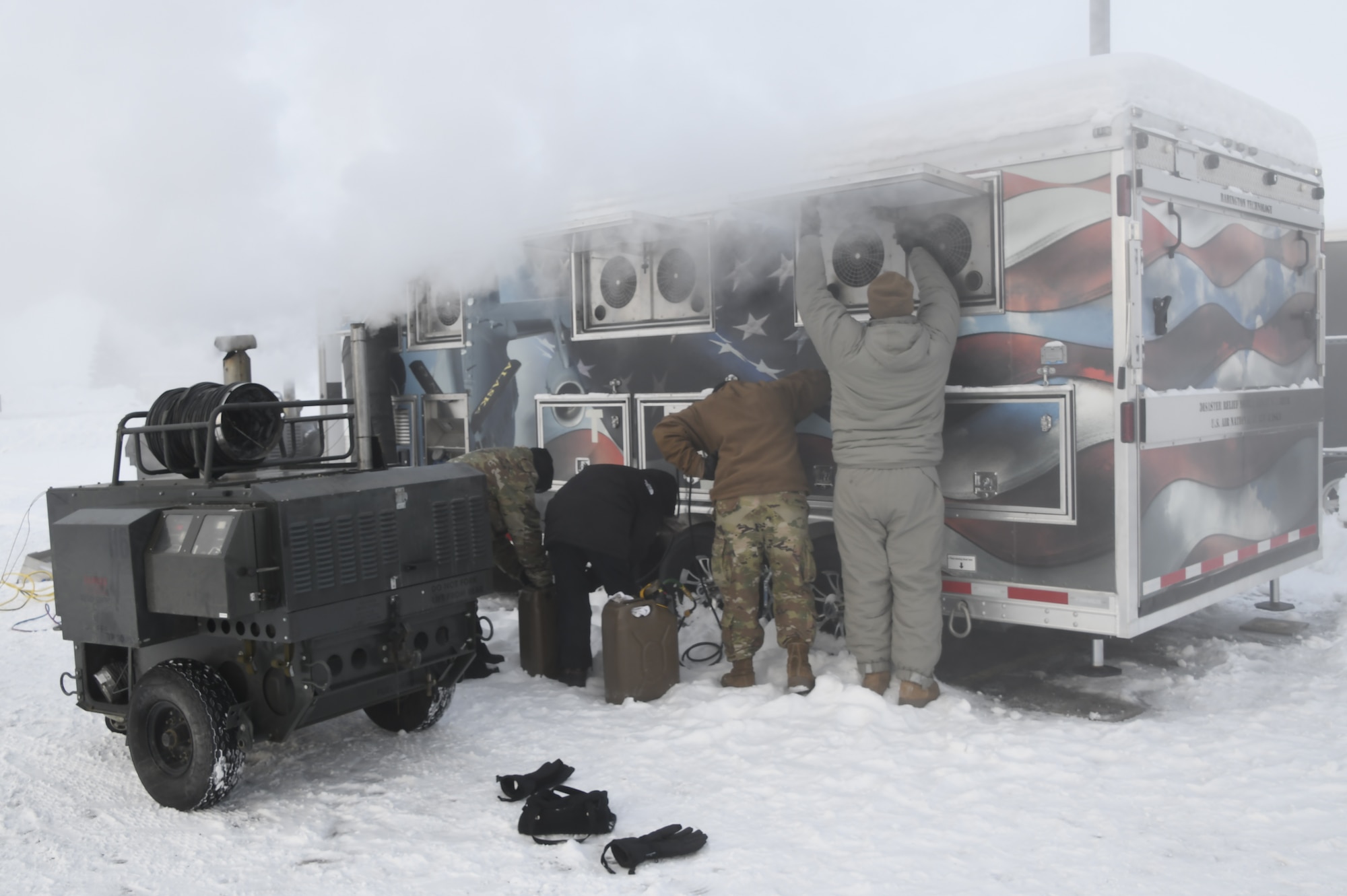 The 168th Services Airmen prepare and test the Disaster Relief Mobile Kitchen trailer in -40 degree temperatures.