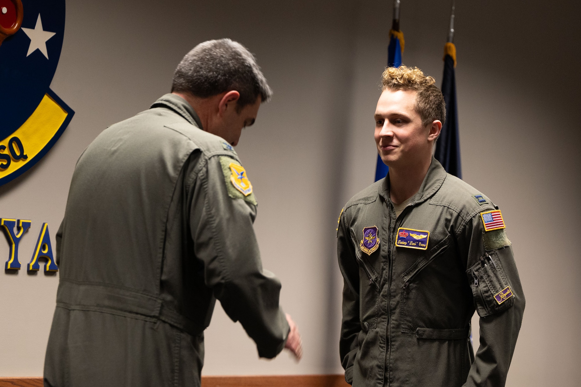 U.S. Air Force Col. Rusty Gohn, 436th Airlift Wing deputy commander, presents the 436th Airlift Wing Commander’s Coin to Capt. Zachary Evans, 3rd Airlift Squadron pilot, at Dover Air Force Base, Delaware, Feb. 9, 2024. Evans was being honored for rescuing a man from a burning vehicle, who had broken both legs in the accident. (U.S. Air Force photo by Airman 1st Class Dieondiere Jefferies)