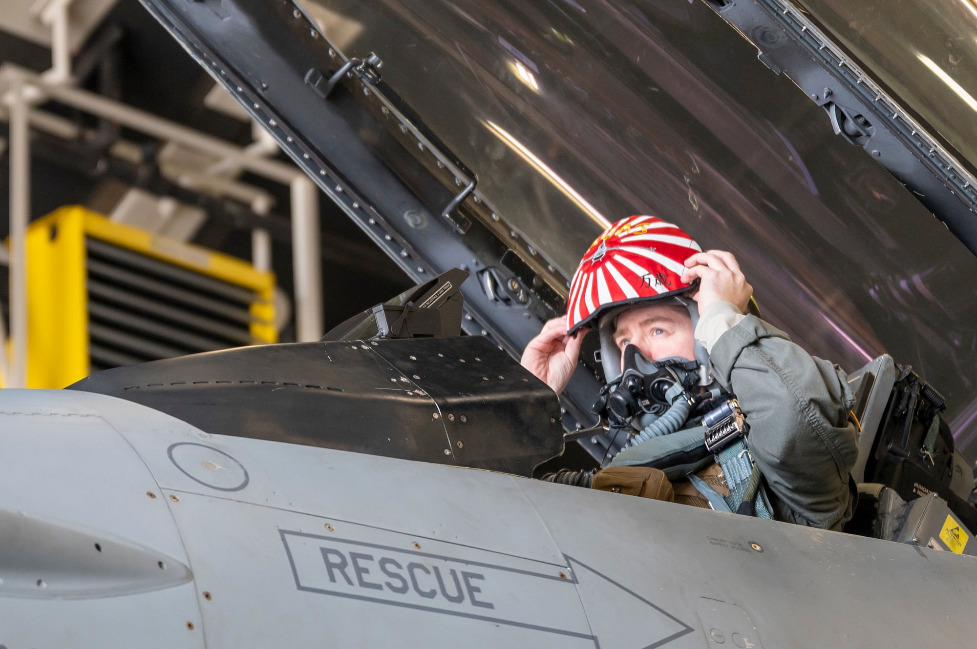 U.S. Air Force Lt. Col. Joshua Pelocincki, 14th Fighter Squadron commander, dons his headgear at Misawa Air Base, Japan, Feb. 2, 2024.