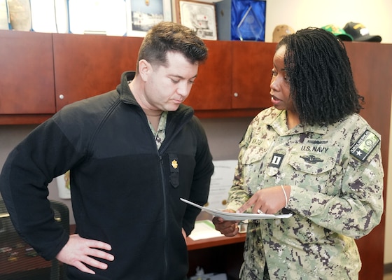 JOINT BASE SAN ANTONIO-FORT SAM HOUSTON – (Feb. 13, 2024) – U.S. Navy Lt. Zainob Andu, of Chicago, a regional logistician and assistant deputy chief of staff for logistics, assigned to Naval Medical Forces Support Command (NMFSC), briefs Lt. Cmdr. Wesley Poirier, deputy chief of staff for logistics, on the command’s scheduled Medical Inspector General Inspection at NNFSC headquarters. Zainob, who was commissioned through the Medical Service Corps In-service Procurement Program, is a representation of the highly professional and diverse active-duty workforce within the Department of the Navy. NMFSC develops and delivers integrated education and training that produces operational medical experts to project Medical Power in support of Naval Superiority. (U.S. Navy Photo by Burrell Parmer, NMFSC Public Affairs/Released)