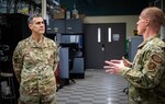 Lt. Gen. Marc Sasseville listens as Capt. Josh Hunsinger briefs on daily operations, missions, and the proud heritage of the Communications Squadron, Bangor Air National Guard Base, Maine, Feb. 3, 2024. Sasseville toured the Wing and met with the MAINEiacs as part of a multiday event.