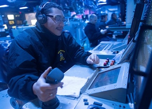 FC2 Borbonga scans for surface vessels in the combat information center aboard USS Dewey (DDG 105) in the Philippine Sea.