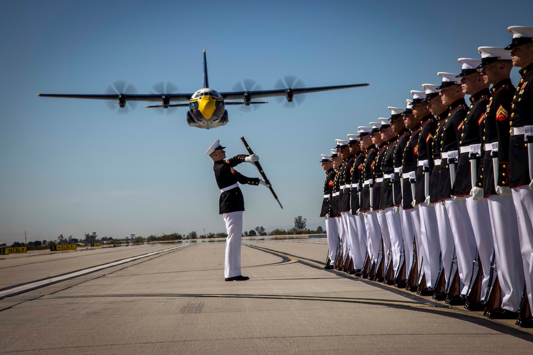 Corporal Gerald Wells III, rifle inspector, Silent Drill Platoon, conducts a rifle inspection during the Blue Angels “Fat Albert” C-130J Super Hercules fly-over at Marine Corps Air Station, Yuma, Ariz., Feb. 13, 2024. The performance was the start of this year’s Battle Color Detachment Tour.