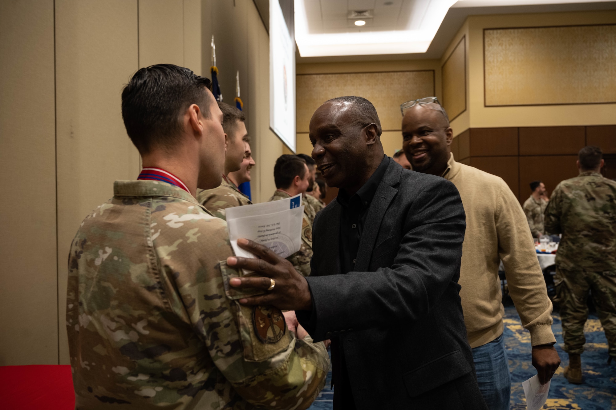 Audience member congratulates graduate