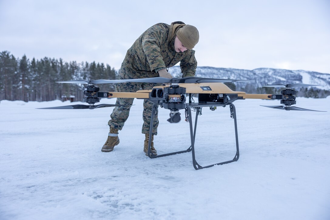 U.S. Marine Corps Lance Cpl. Andrew Hill, a motor transport operator assigned to Combat logistics Battalion 6, Combat Logistics Regiment 2, 2nd Marine Logistics Group, fastens the propeller arms on a Tactical Resupply Vehicle 150 (TRV) unmanned aircraft system during test flight operations in Setermoen, Norway, Feb. 6, 2024.  CLB-6 conducted the test flights to study the performance and capabilities of the TRV-150 drone in artic climates and to increase system familiarization. CLB-6 is in Norway as part of Marine Rotational Forces Europe 24.1, which focuses on regional engagements throughout Europe by conducting various exercises, arctic cold-weather and mountain warfare training, and military-to-military engagements, which enhance overall interoperability of the U.S. Marine Corps with allies and partners. (U.S. Marine Corps photo by Lance Cpl. Christian Salazar)