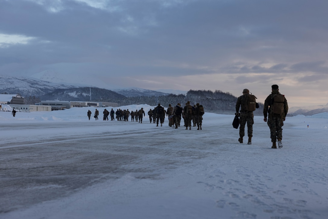 U.S. Marines with the 2nd Marine Aircraft Wing walk on the flight line after disembarking a plane in preparation for Exercise Nordic Response 24 at Bardufoss, Norway, Feb. 7, 2024. Exercise Nordic Response, formerly known as Cold Response, is a NATO training event conducted every two years to promote military competency in arctic environments and to foster interoperability between the U.S. Marine Corps and allied nations. (U.S. Marine Corps photo by Lance Cpl. Orlanys Diaz Figueroa)