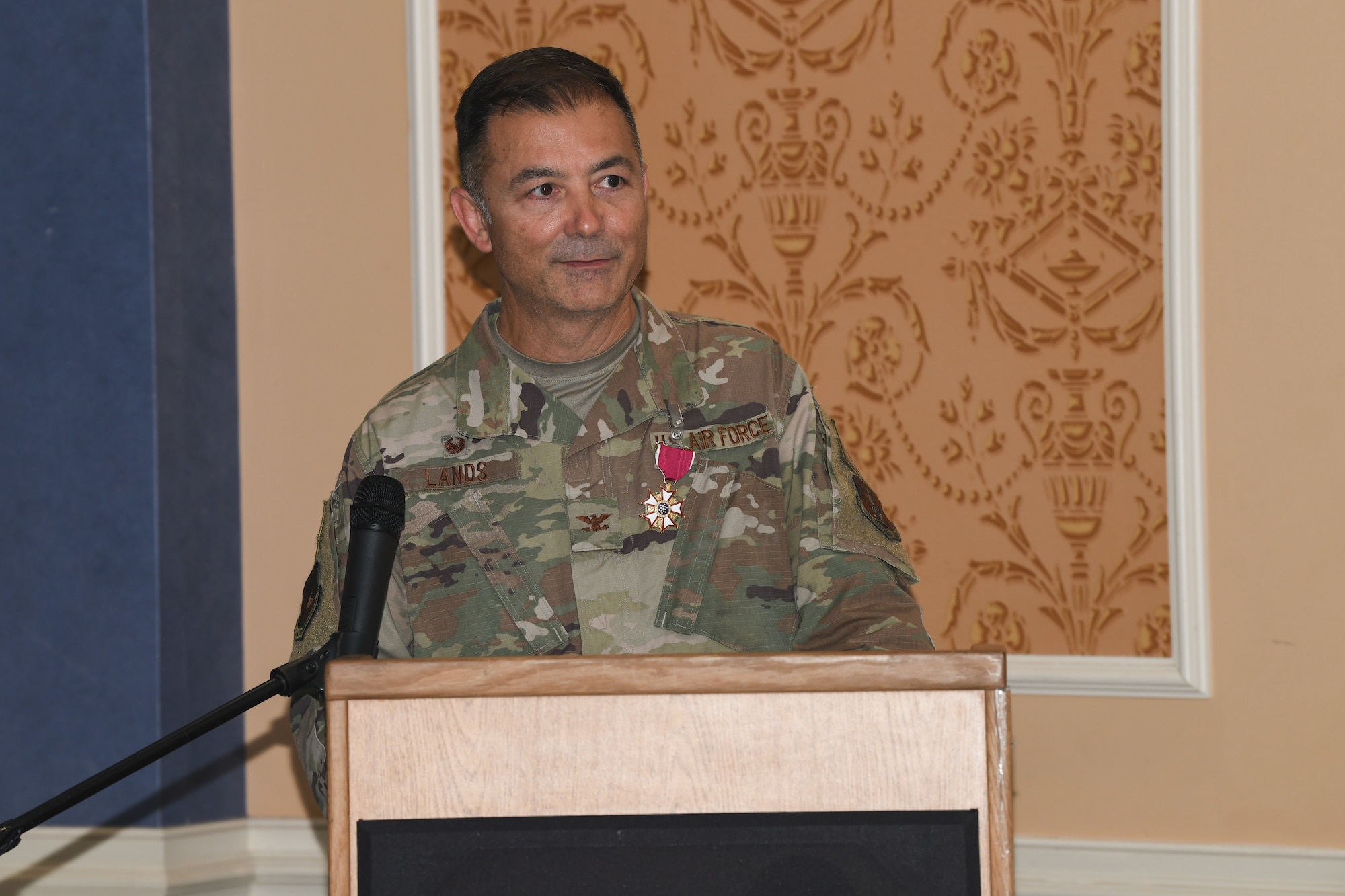 Military member standing at podium.