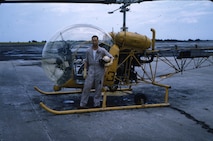 USCG Aviator Bobby Wilks stand next to a H-47 at NAS Ellyson Field, August, 1959.