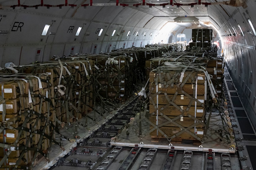Cargo is loaded on a military cargo plane.