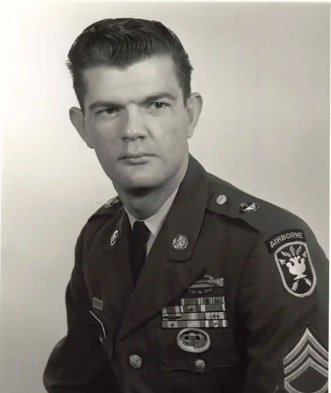 A man in a military dress uniform poses for a photo.