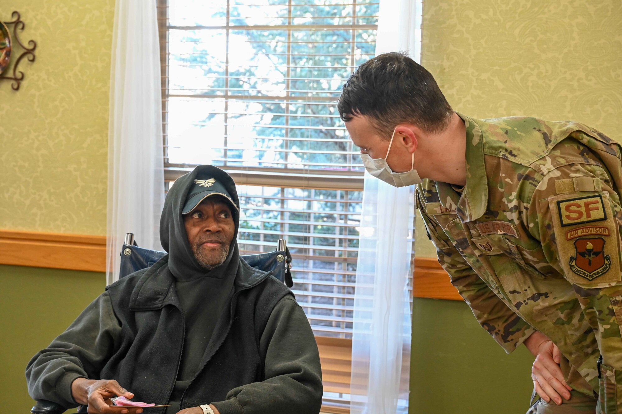 James Mayo, an Air Force veteran, speaks to Tech. Sgt. Dominik Lance, 97th Security Forces Squadron noncommissioned officer in charge of resources protection, at Magnolia Creek in Altus, Oklahoma, Feb. 14, 2024. Mayo served for two years, working in supply. (U.S. Air Force photo by Airman 1st Class Kari Degraffenreed)