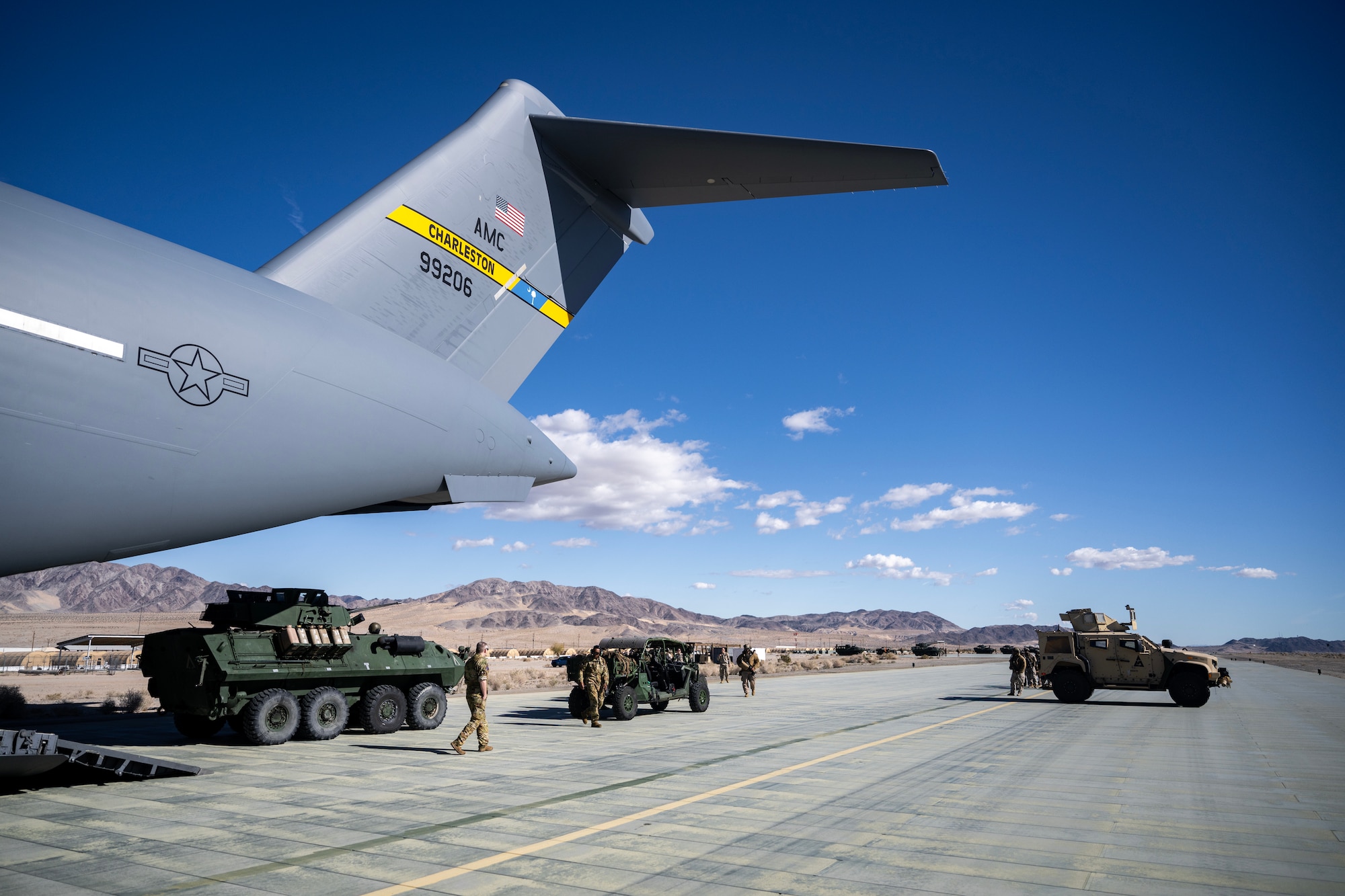U.S. Air Force 14th Airlift Squadron, load vehicles and Marines assigned to the 3rd Light Armored Reconnaissance Battalion, during Bamboo Eagle 24-1, at Marine Corps Air-Ground Combat Center, Twentynine Palms, California, Jan. 25. 2024. Bamboo Eagle provides Airmen, allies and partners a flexible, combat-representative, multidimensional battlespace to conduct testing tactics development, and advanced training in support of U.S. national interests. (U.S. Air Force photo by Senior Airman Mitchell Corley)