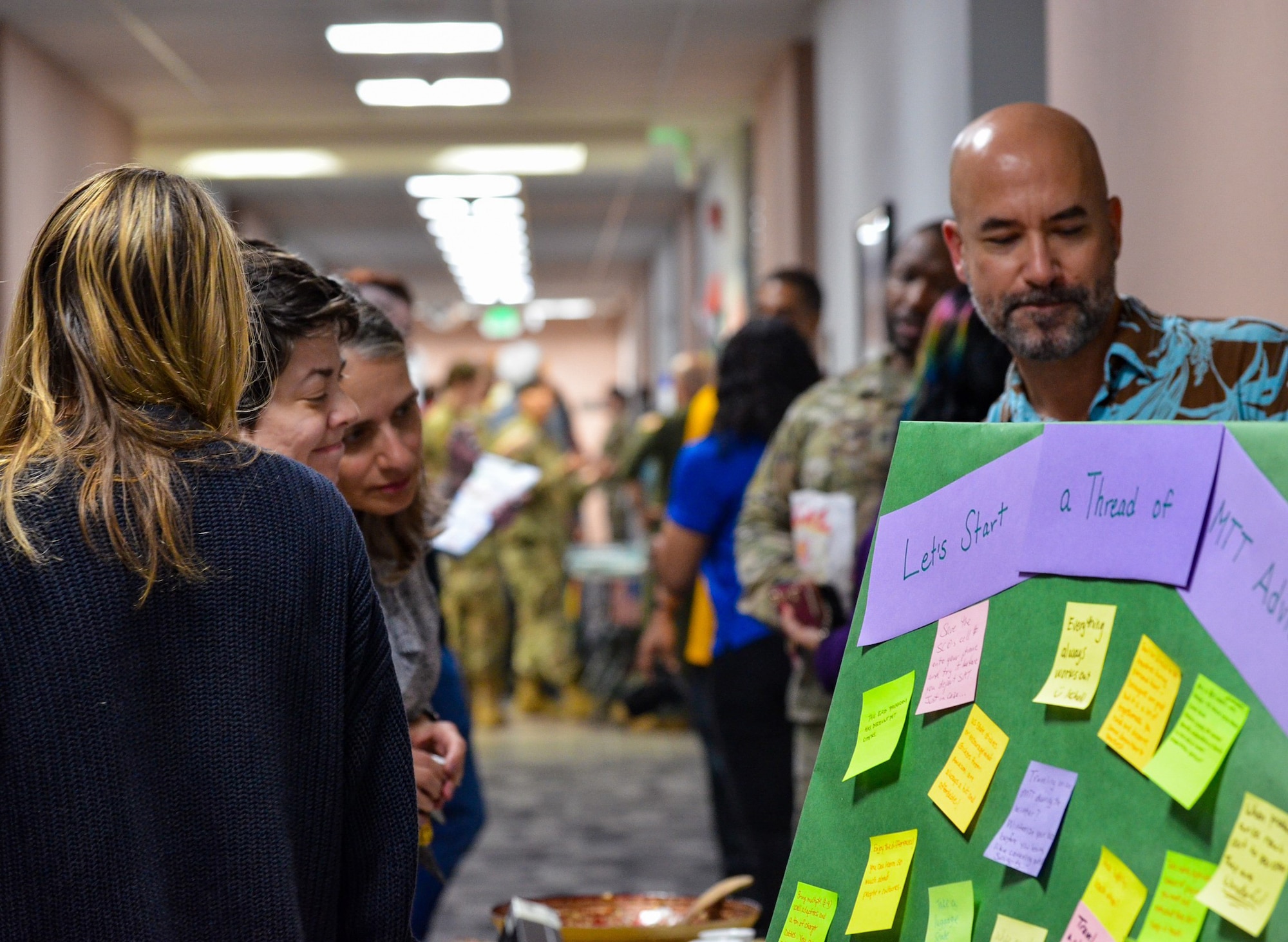 Defense Language Institute English Language Center, Nonresident Program Managers, Murad Khalliev and Robert Donayre, 637th International Support Squadron, represent the International Flight during the DLIELC Showcase at Joint Base San Antonio-Lackland, Texas, Feb. 2, 2024. They share international dishes as part of the learning journey during their interactive trivia quiz. The showcase highlights how each Squadron supports the overall mission in building security cooperation through English language training. (U.S. Air Force photo by Agnes Koterba)