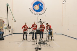 On May 3, 2023, the United States Marine Band performed in the acoustic testing chamber at Goddard Space Flight Center in Greenbelt, Md., to see if it could reach the volume that the Plankton, Aerosol, Cloud and ocean Ecosystem (PACE) spacecraft would be exposed to when launched by rocket into orbit.

As a part of the visit, musicians had the opportunity to test their sound in their instrument groups. Here, percussionists play as loud as they can while monitored by volume measuring devices. 

(U.S. Marine Corps photo by Master Gunnery Sgt. Amanda Simmons/released)