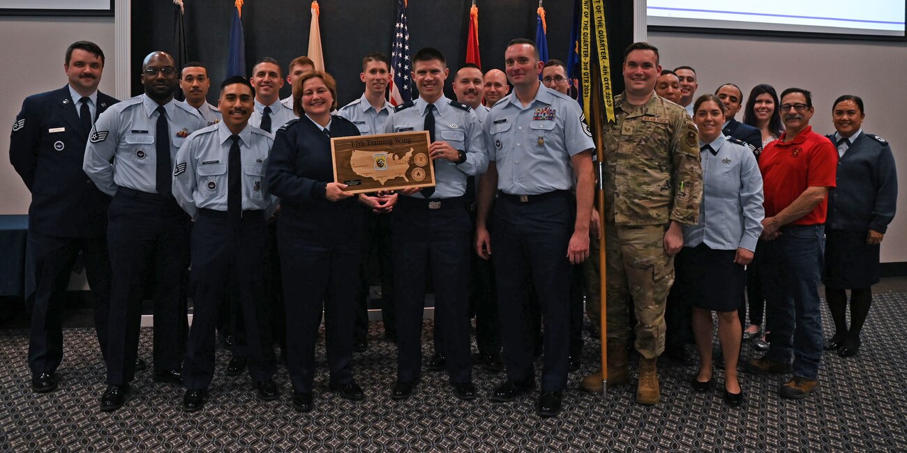 Airmen assigned to the 312th Training Squadron pose for a group photo with 17th Training Wing leadership during the 17th TRW 4th Quarterly Awards Ceremony at the Powell Event Center, Goodfellow Air Force Base, Texas, Feb. 2, 2023. The 312th TRS received the Unit of the Quarter award to honor all members for their exceptional accomplishments and performance. (U.S. Air Force photo by Airman 1st Class Evelyn J. D'Errico)