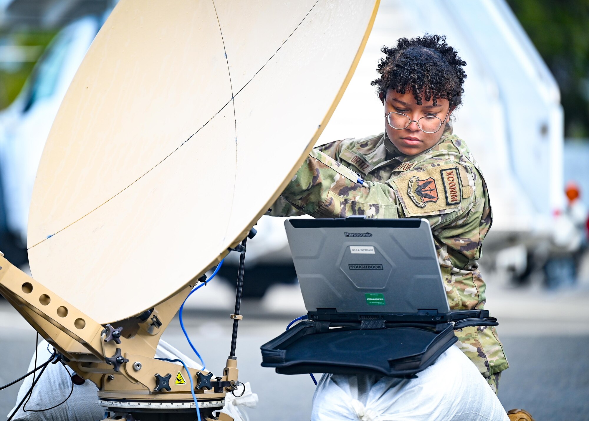 An Airman adjusts a satellite dish.