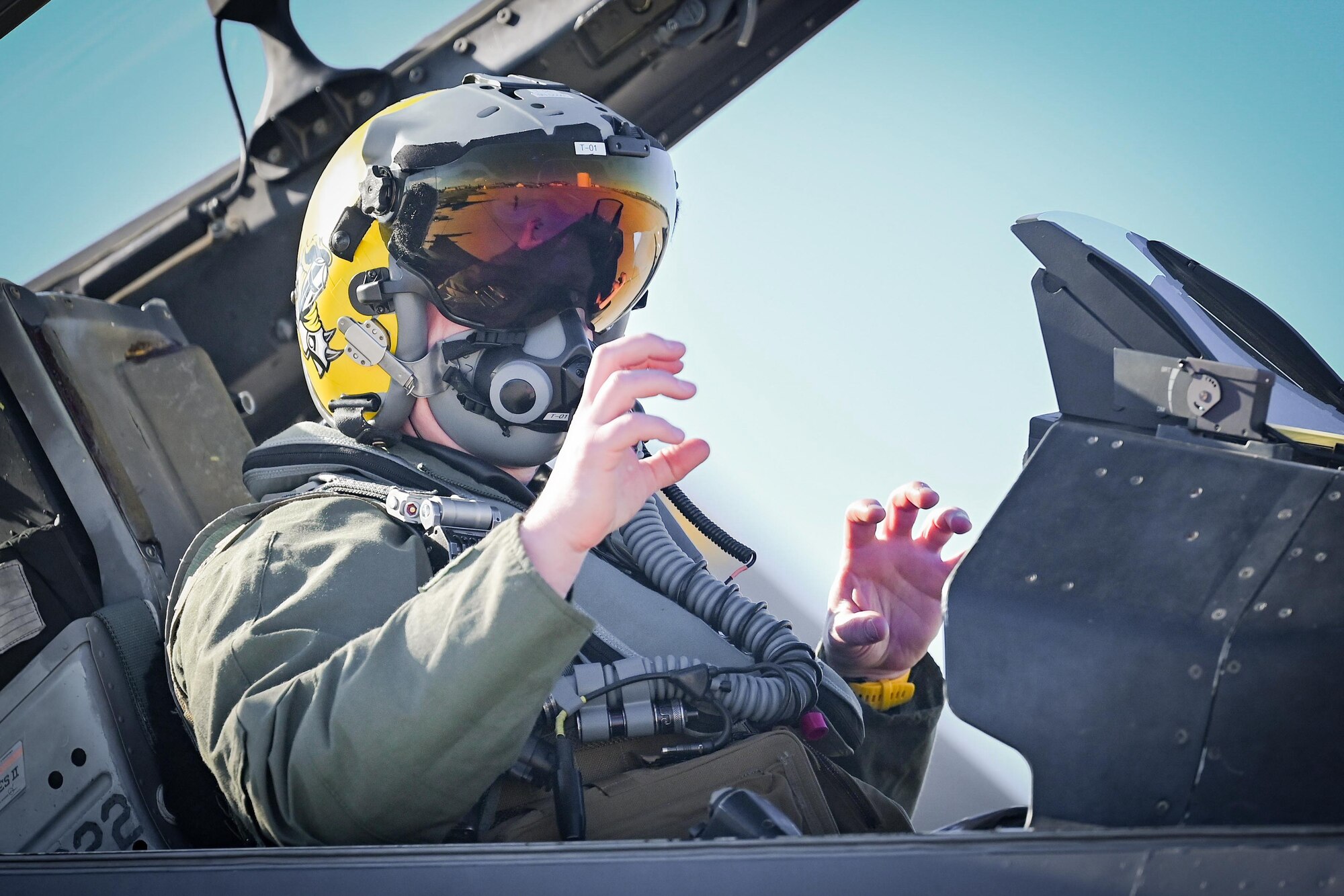 A pilot displays squadron hand signals.