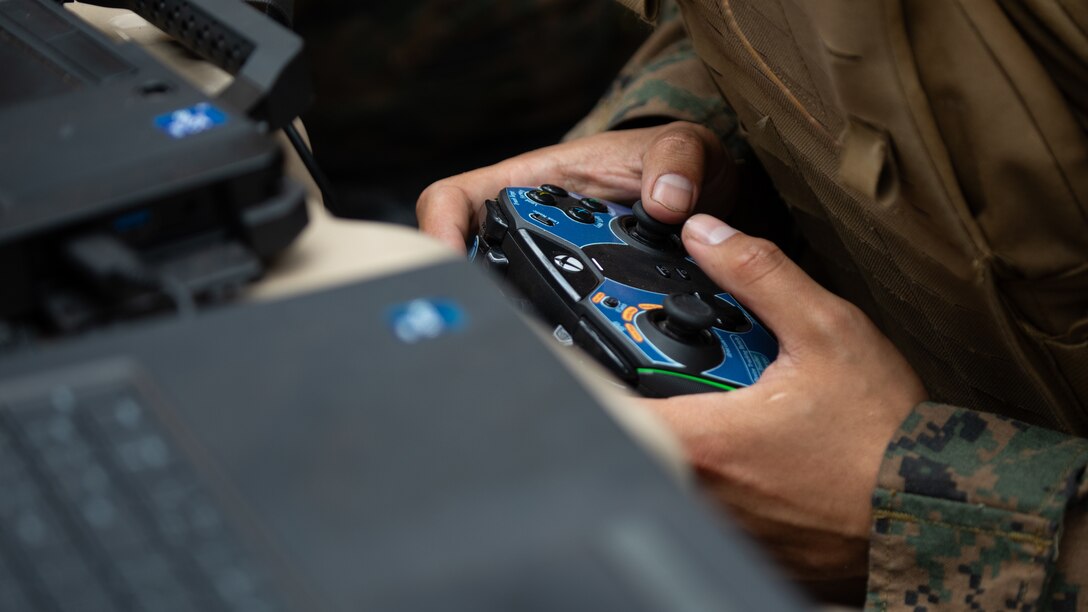 A U.S. Marine with 3d Littoral Combat Team, 3d Marine Littoral Regiment, 3d Marine Division remotely controls a small unmanned aircraft system during a training evolution at Marine Corps Training Area Bellows, Hawaii, Jan. 24, 2024. The training experimented with the Littoral Reconnaissance Team concept while operating multiple advanced data collection systems and assets, such as the Stalker VXE30 small unmanned aerial system. (U.S. Marine Corps photo by Sgt. Jacqueline C. Parsons)