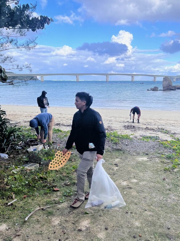U.S. Marines and Sailors dispose of trash during a volunteer beach cleanup at the National Sanitorium in Okinawa, Japan, Dec. 22, 2023. The Marines and Sailors of 2d Battalion, 2d Marine Regiment dedicated 770 hours to community service during their six-month deployment in Okinawa. The battalion contributed to the local community by cleaning up trash on local beaches, provided English lessons at local schools and sponsored a foster home during the holiday season.  2/2 is forward deployed in the Indo-Pacific under 4th Marine Regiment, 3d Marine Division as part of the Unit Deployment Program. (Courtesy Photo)