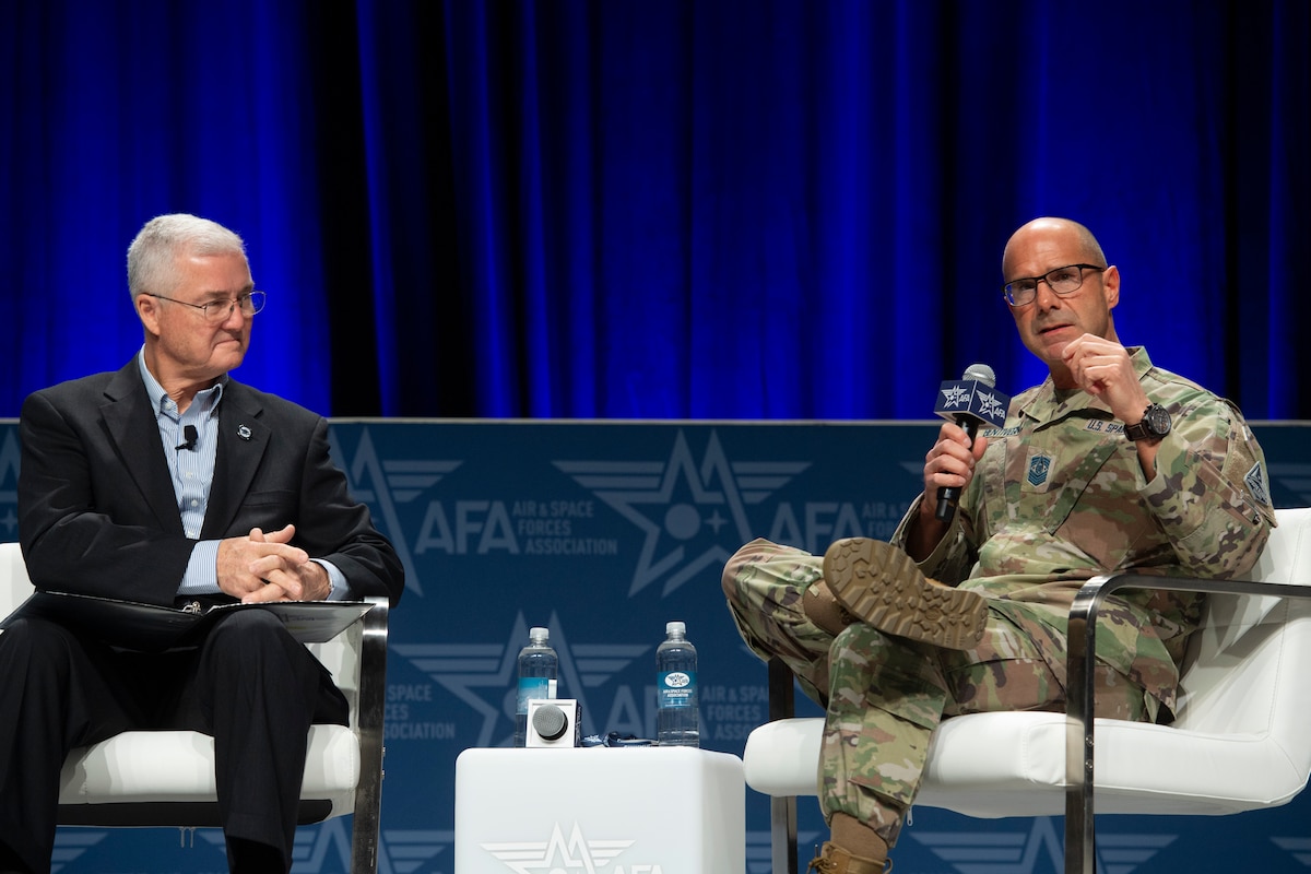 Chief Master Sgt. of the Space Force John Bentivegna speaks with Gerald Murray, moderator and 14th Chief Master Sgt. of the Air Force, about the importance of properly empowering, training and equipping the enlisted force to prepare for Great Power Competition during a panel Feb. 14, 2024, at the Air and Space Forces Warfare Symposium in Aurora, Colo.
