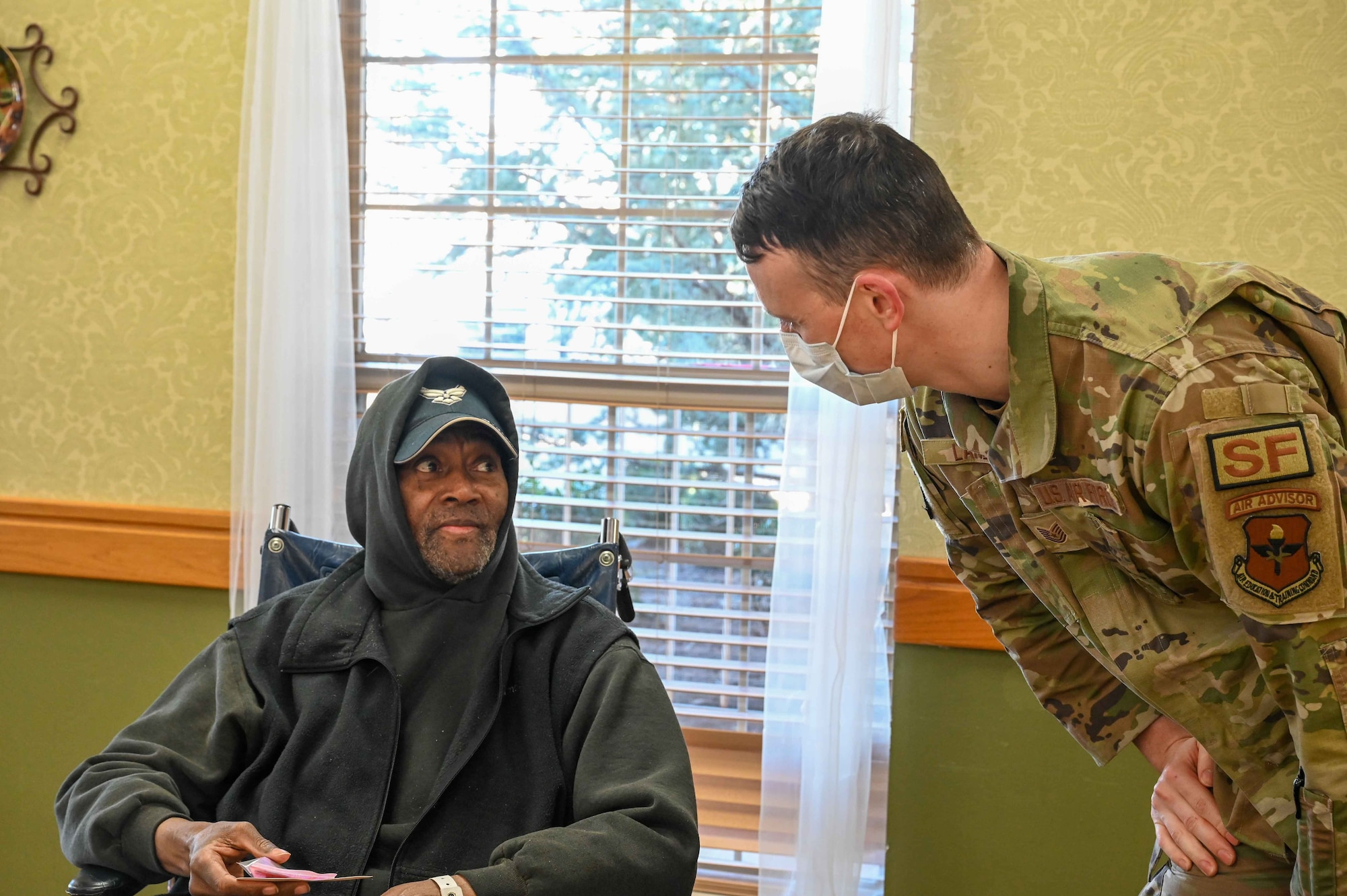 James Mayo, an Air Force veteran, speaks to Tech. Sgt. Dominik Lance, 97th Security Forces Squadron noncommissioned officer in charge of resources protection, at Magnolia Creek in Altus, Oklahoma, Feb. 14, 2024. Mayo served for two years, working in supply. (U.S. Air Force photo by Airman 1st Class Kari Degraffenreed)