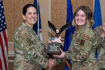 A general and Airman holding trophy