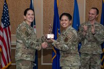 A general and Airman holding a trophy