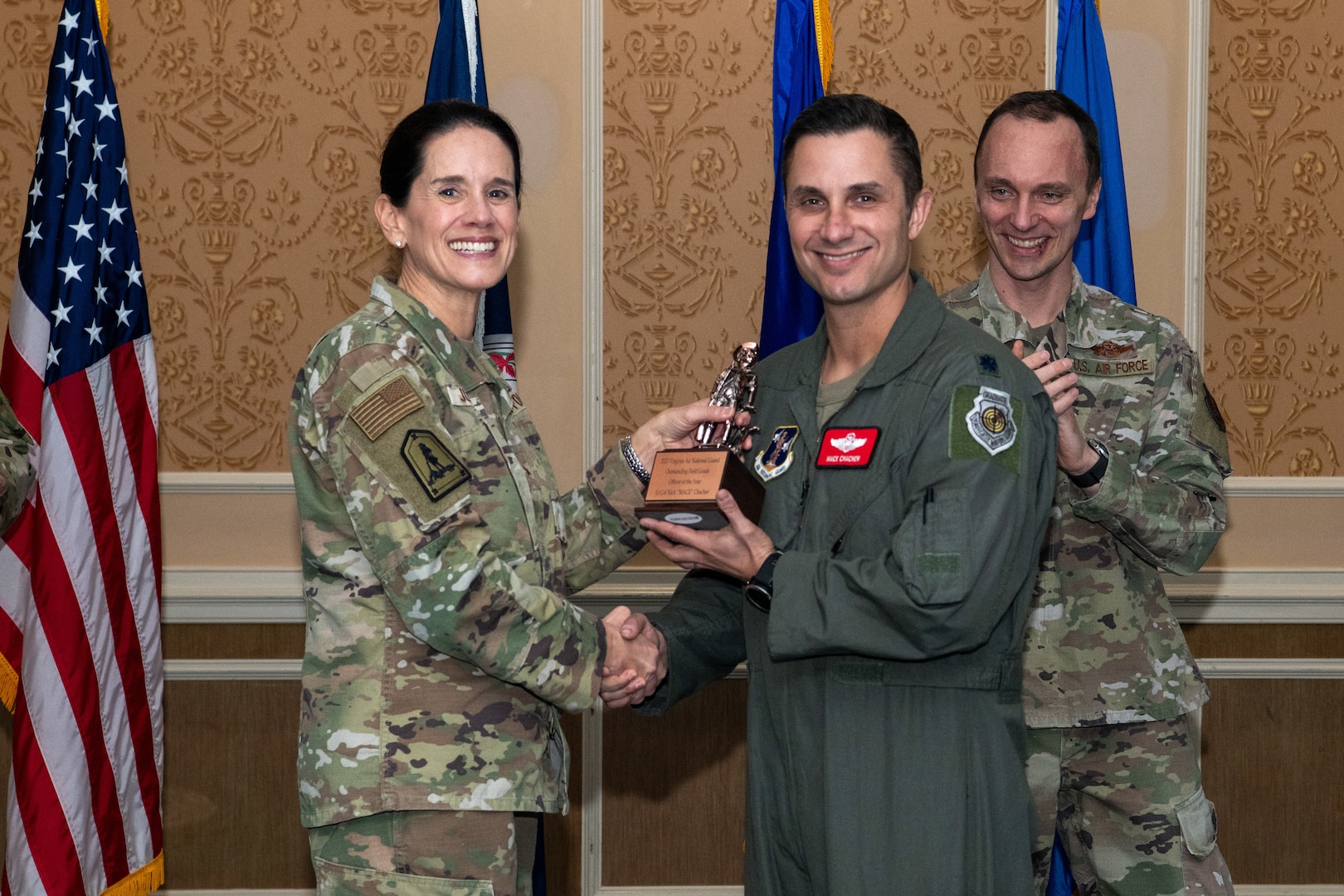 A general and lieutenant colonel holding trophy