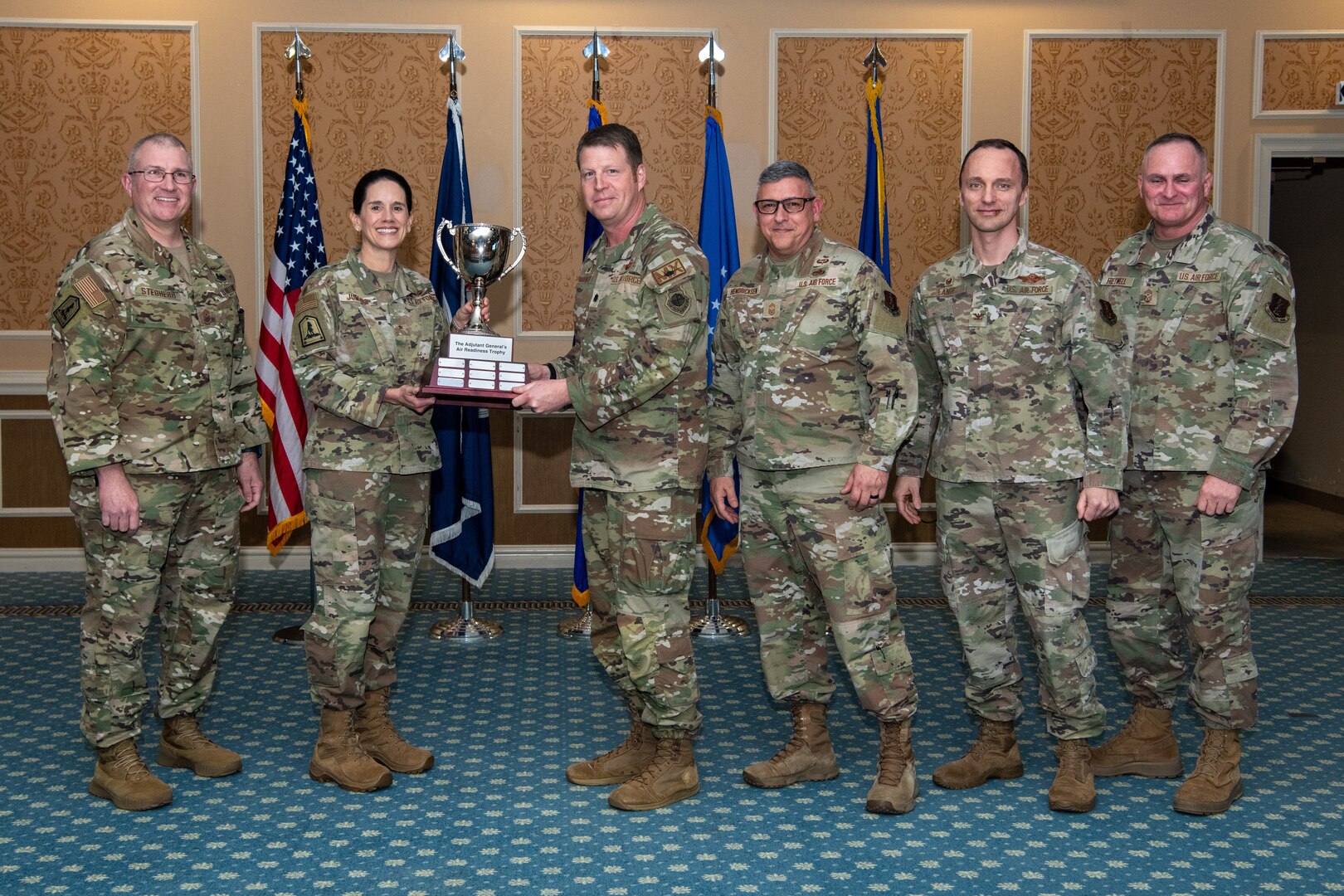 group of Airmen holding trophy