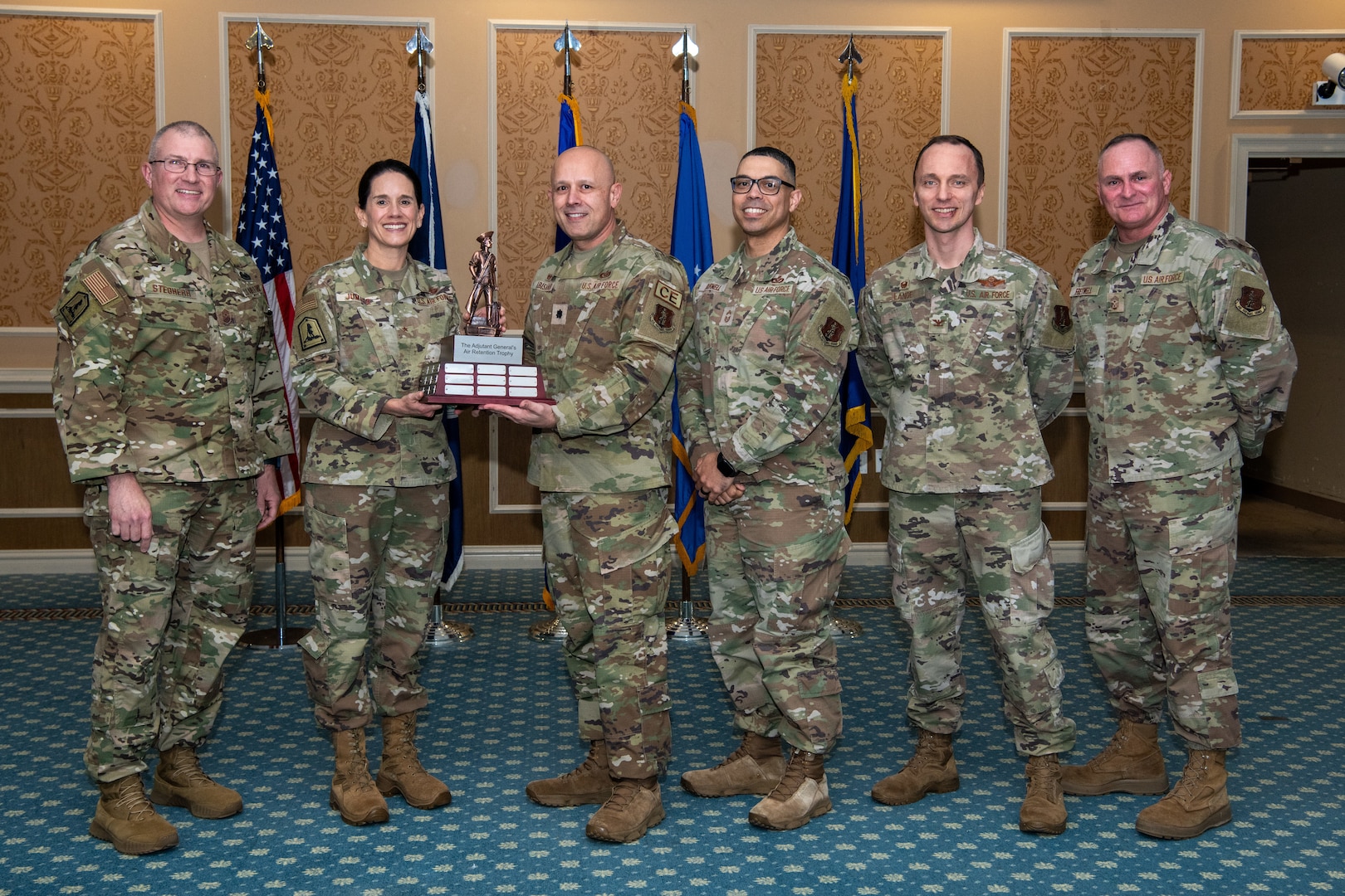 group of Airmen holding trophy