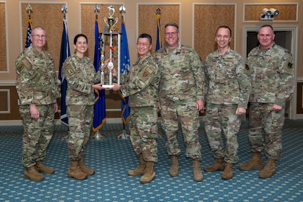 group of Airmen holding trophy