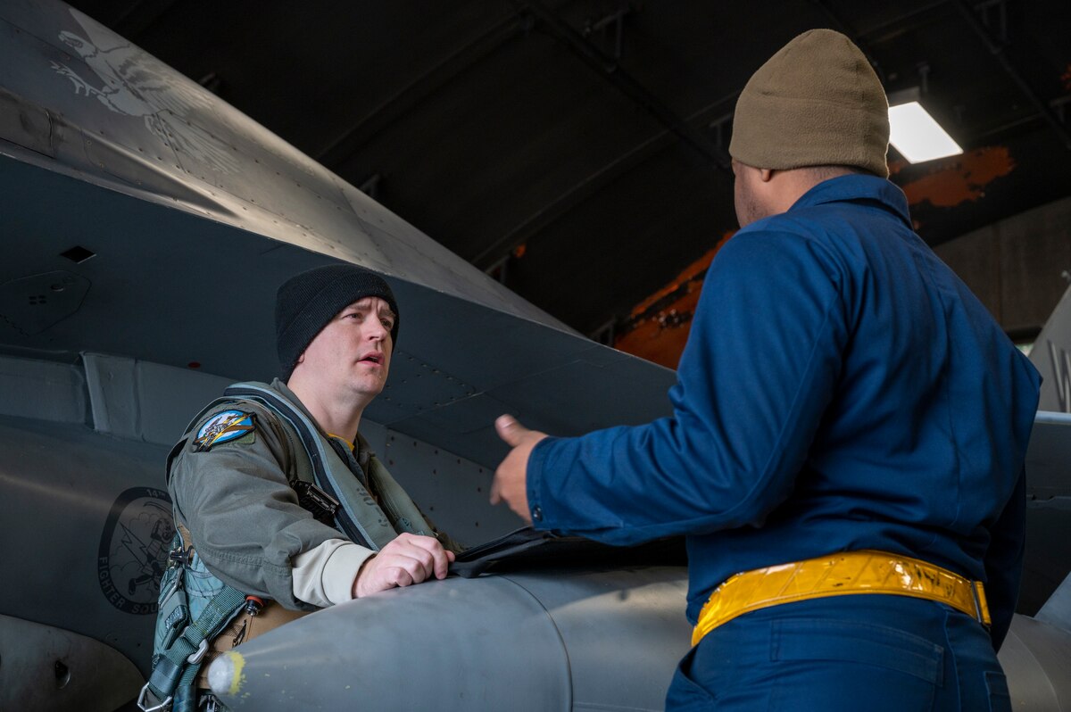 U.S. Air Force Lt. Col. Joshua Pelocincki, 14th Fighter Squadron commander, discusses Cope North 24 with Senior Airman Issac Gary, 35th Maintenance Squadron F-16 crew chief at Misawa Air Base, Japan, Feb. 2, 2024.